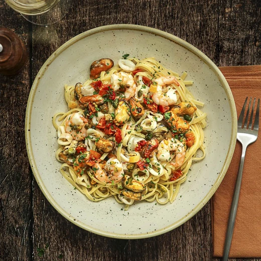 Moules, crevettes, encornets, crème, fromage italien râpé, huile vierge à la tomate et à la pistache Moules, crevettes, encornets, crème, fromage italien râpé, huile vierge à la tomate et à la pistache