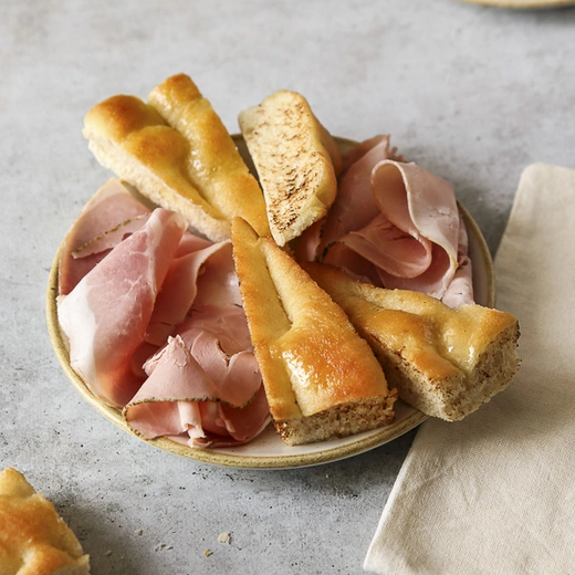 Assiette de charcuterie, servie avec du pain focaccia Assiette de charcuterie, servie avec du pain focaccia